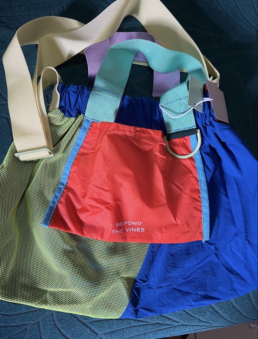 Beyond The Vines Super Panelled XS Dumpling bag (Category: Cross-body Bags) located in Las Pinas. Submitted by silver_mamadeclutters (Listing ID 1465931672, Image 1). Description: - Brand: Beyond The Vines - Condition: Brand new with hang tags and interior tag attached - Material: 100% durable nylon - Design: Vibrant colorblock in blue, red, neon yellow mesh, and mint green - Pockets & Details: Orange front pocket with white text logo - Strap: Ad