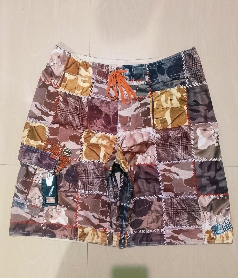 Billabong Patchwork Camo Boardshorts Size 33 (Category: Swim Trunks & Board Shorts) located in Munoz. Submitted by rogelioarq16817 (Listing ID 1465896710, Image 1). Description: Billabong boardshorts in a multi-color camo patchwork design. Orange drawstring waist with branded eyelets. Side cargo pocket with an attached wax comb bottle opener. 100% polyester material, style number M1015VAG. Size 33 tag inside. width 33/36 fit length 23 leg opening