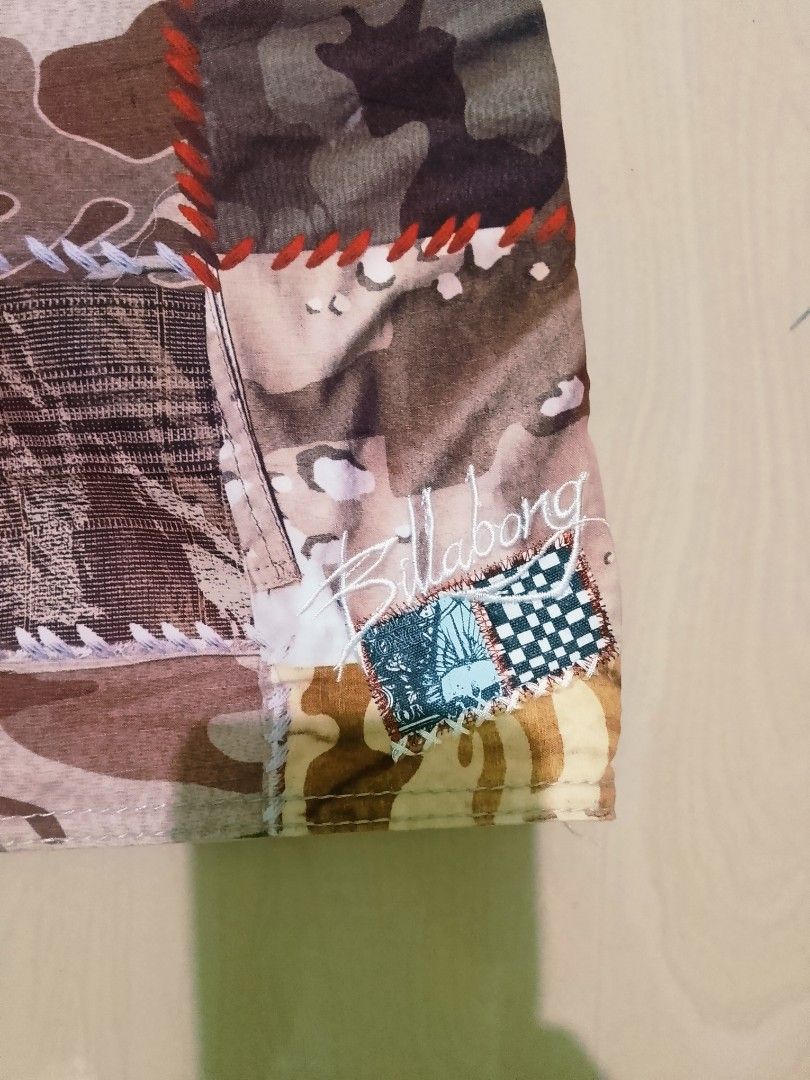 Billabong Patchwork Camo Boardshorts Size 33 (Category: Swim Trunks & Board Shorts) located in Munoz. Submitted by rogelioarq16817 (Listing ID 1465896710, Image 3). Description: Billabong boardshorts in a multi-color camo patchwork design. Orange drawstring waist with branded eyelets. Side cargo pocket with an attached wax comb bottle opener. 100% polyester material, style number M1015VAG. Size 33 tag inside. width 33/36 fit length 23 leg opening
