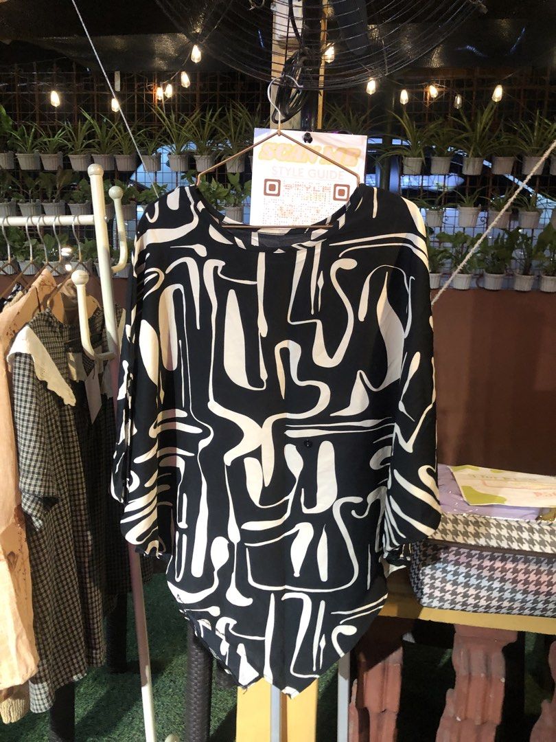 Black and White Abstract Print Blouse (Category: Blouses) located in Cauayan City . Submitted by wholly.craaaft (Listing ID 1465874530, Image 1). Description: - Trendy black and white abstract line design - Lightweight, breathable fabric for all-day comfort - Relaxed fit with stylish drop shoulder sleeves - Classic round neckline and flattering curved hem - Easy to pair with jeans for casual days or trousers for work.
