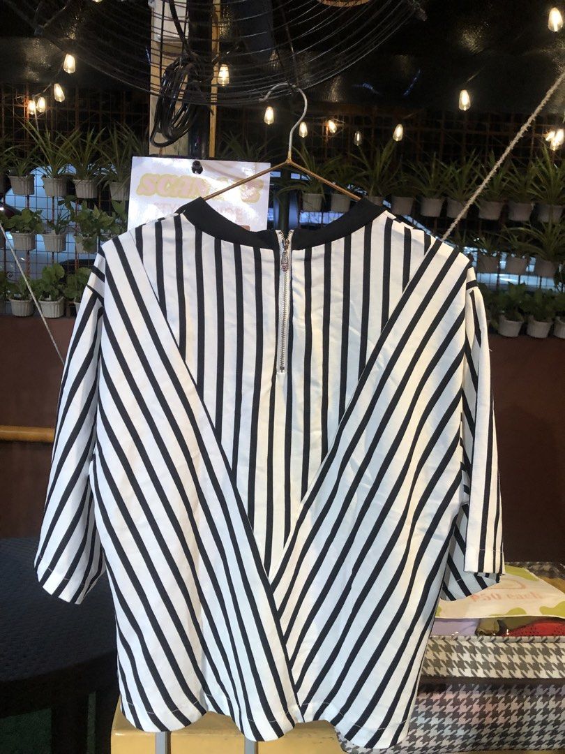 Black and White Striped Blouse (Category: Blouses) located in Cauayan City . Submitted by wholly.craaaft (Listing ID 1465874232, Image 3). Description: - Style: Black and white vertical stripes - Fit: Relaxed and lightweight for all-day comfort - Details: Contrast black rounded neckline & exposed silver back zipper - Sleeves: Short sleeves - Size: Medium (160/84A) - Condition: Excellent, ready to wear.