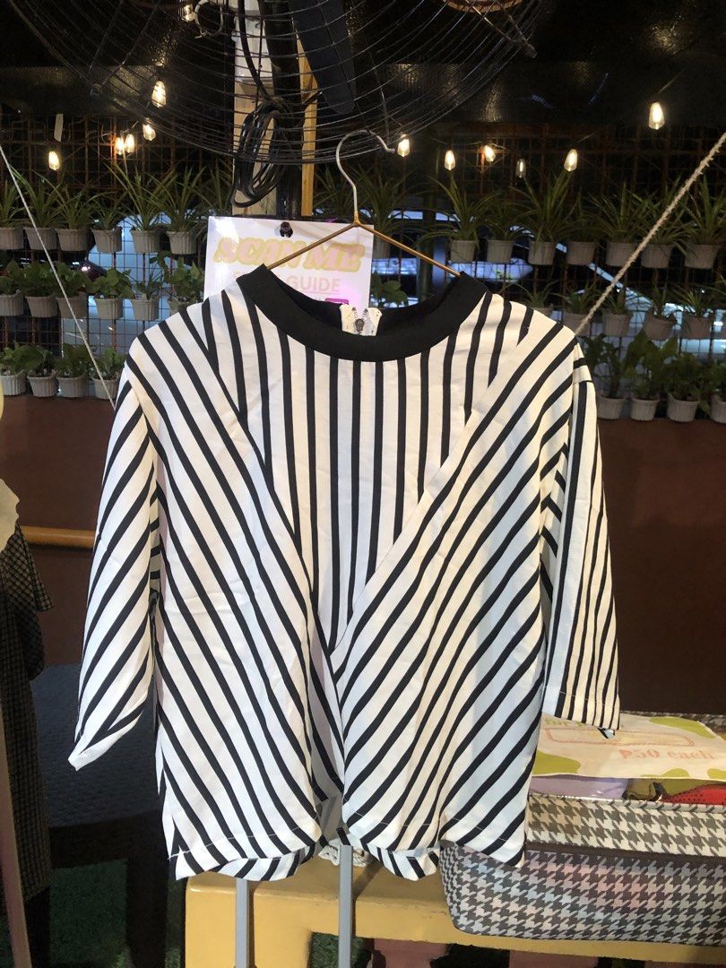 Black and White Striped Blouse (Category: Blouses) located in Cauayan City . Submitted by wholly.craaaft (Listing ID 1465874232, Image 1). Description: - Style: Black and white vertical stripes - Fit: Relaxed and lightweight for all-day comfort - Details: Contrast black rounded neckline & exposed silver back zipper - Sleeves: Short sleeves - Size: Medium (160/84A) - Condition: Excellent, ready to wear.
