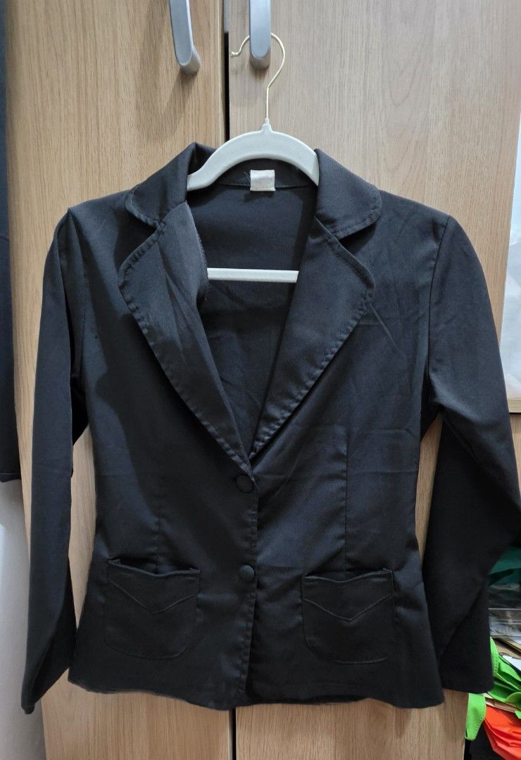 Black blazer jacket with two buttons and front pockets (Category: Coats, Jackets and Outerwear) located in Manila. Submitted by tori_mama21 (Listing ID 1465815052, Image 1). Description: - Color: Solid black - Style: Classic lapel collar, double-button front closure - Fit: Fitted cut with long sleeves - Features: Two functional flap pockets near the hem - Versatility: Ideal for corporate wear, interviews, or smart-casual outfits.