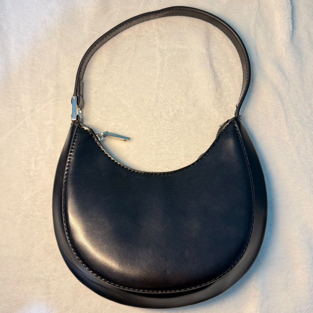 Mango Black crescent shoulder bag minimalist half moon purse (Category: Shoulder Bags) located in Binangonan. Submitted by joeydrs06 (Listing ID 1465948042, Image 1). Description: - Color: Black - Material: Smooth faux leather with silver-tone hardware - Design: Crescent shape with a structured curved bottom and contrast stitching - Closure: Secure zipper closure - Strap: Short single strap designed for comfortable under-arm wear - Interior: Clea