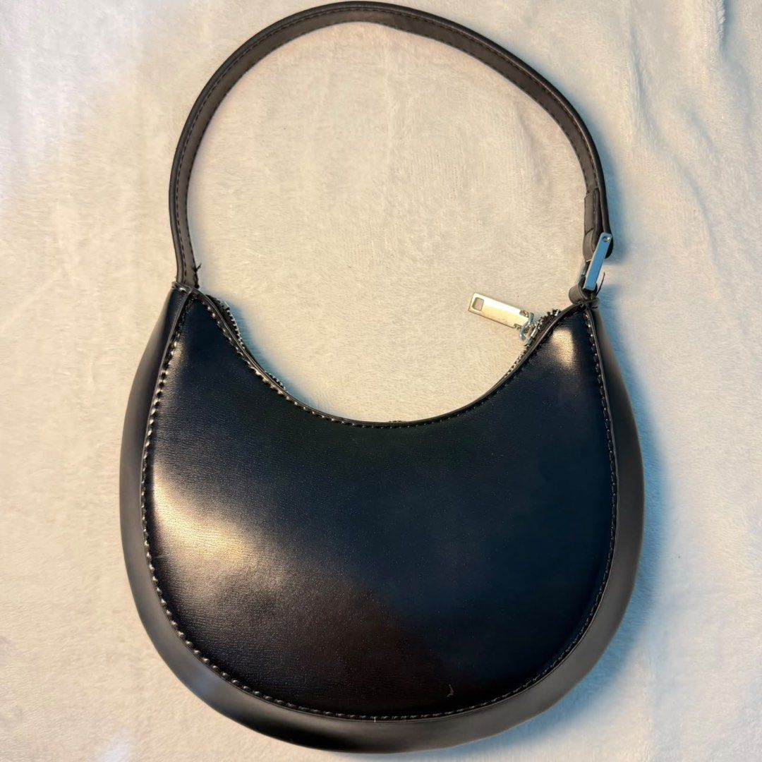 Mango Black crescent shoulder bag minimalist half moon purse (Category: Shoulder Bags) located in Binangonan. Submitted by joeydrs06 (Listing ID 1465948042, Image 2). Description: - Color: Black - Material: Smooth faux leather with silver-tone hardware - Design: Crescent shape with a structured curved bottom and contrast stitching - Closure: Secure zipper closure - Strap: Short single strap designed for comfortable under-arm wear - Interior: Clea