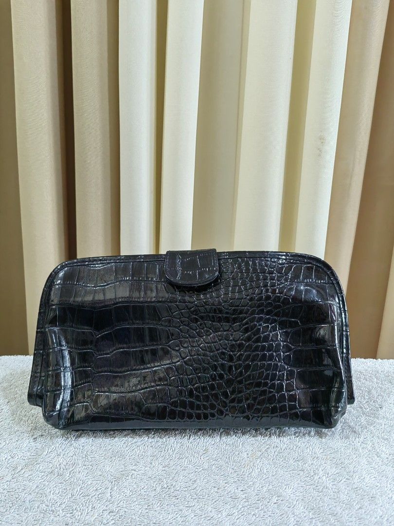 Black Croc Embossed Makeup Pouch Clutch Bag (Category: Purses & Pouches) located in Makati City. Submitted by prelovedtreatedwithlove (Listing ID 1465784075, Image 1). Description: - Stylish black croc-embossed design with a glossy patent finish - Secure foldover flap with magnetic snap closure - Transparent interior compartments with zippers for easy visibility and organization - Structured rectangular shape offering ample space for makeup brush