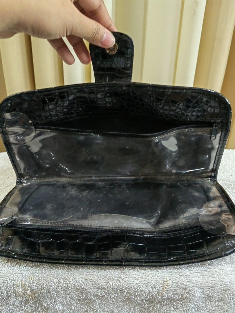 Black Croc Embossed Makeup Pouch Clutch Bag (Category: Purses & Pouches) located in Makati City. Submitted by prelovedtreatedwithlove (Listing ID 1465784075, Image 2). Description: - Stylish black croc-embossed design with a glossy patent finish - Secure foldover flap with magnetic snap closure - Transparent interior compartments with zippers for easy visibility and organization - Structured rectangular shape offering ample space for makeup brush