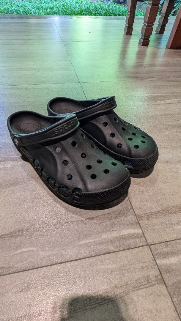 Black Crocs Clogs Size 12 (Category: Slippers & Slides) located in Manila. Submitted by bryanep (Listing ID 1465759900, Image 1). Description: - Brand/Model: Black Crocs clogs - Size: Men's US 12 - Design: Classic slip-on with ventilation holes on top and sides - Fit: Adjustable heel strap for extra security - Traction: Textured outsole for reliable grip - Origin: Made in Indonesia - Condition: Normal wear on soles and footbeds from regular use.