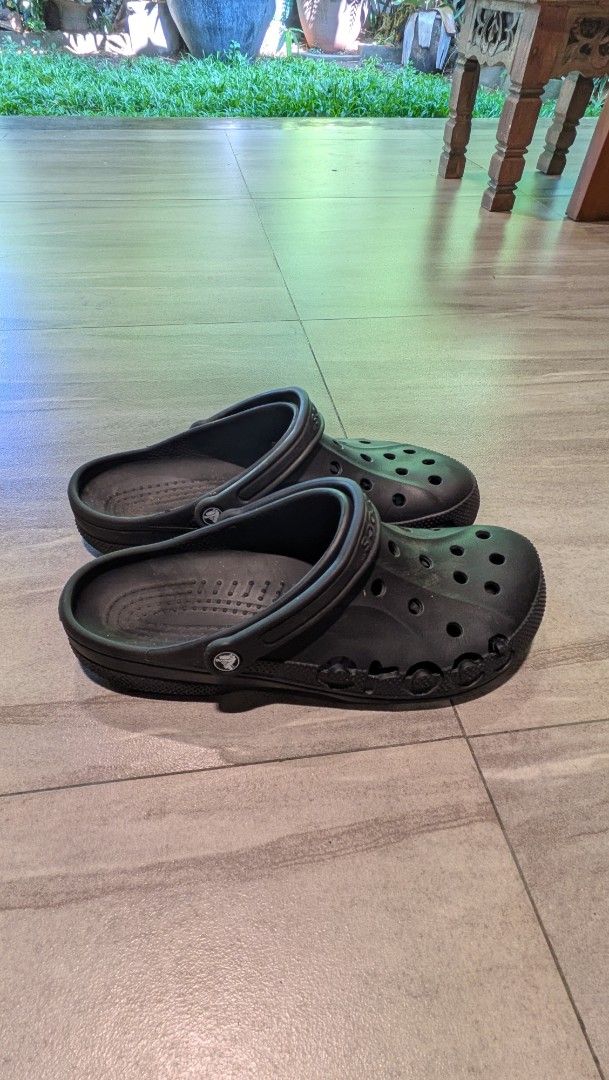 Black Crocs Clogs Size 12 (Category: Slippers & Slides) located in Manila. Submitted by bryanep (Listing ID 1465759900, Image 3). Description: - Brand/Model: Black Crocs clogs - Size: Men's US 12 - Design: Classic slip-on with ventilation holes on top and sides - Fit: Adjustable heel strap for extra security - Traction: Textured outsole for reliable grip - Origin: Made in Indonesia - Condition: Normal wear on soles and footbeds from regular use.