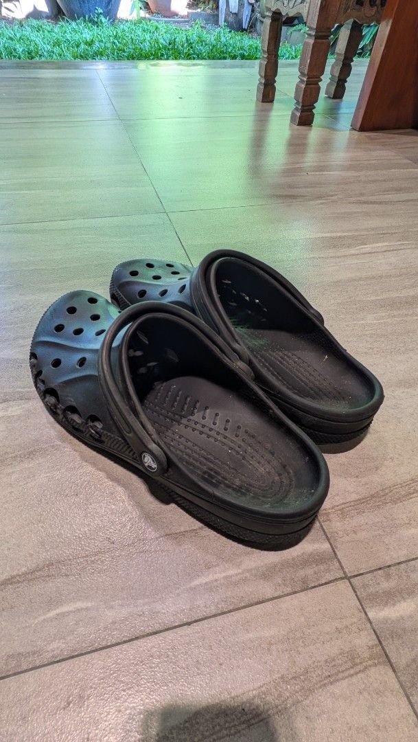 Black Crocs Clogs Size 12 (Category: Slippers & Slides) located in Manila. Submitted by bryanep (Listing ID 1465759900, Image 2). Description: - Brand/Model: Black Crocs clogs - Size: Men's US 12 - Design: Classic slip-on with ventilation holes on top and sides - Fit: Adjustable heel strap for extra security - Traction: Textured outsole for reliable grip - Origin: Made in Indonesia - Condition: Normal wear on soles and footbeds from regular use.