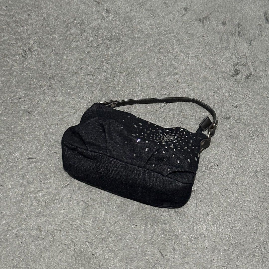 Black Denim Shoulder Bag with Rhinestone Detailing (Category: Shoulder Bags) located in Lipa City. Submitted by jecoparra (Listing ID 1465842082, Image 2). Description: - Style: Black denim shoulder bag with a soft, slouchy design - Detailing: Sparkling rhinestone starburst pattern on the front - Straps & Hardware: Short dark brown strap with sleek silver hardware - Storage: Main compartment for daily essentials plus a full-width back zippered po