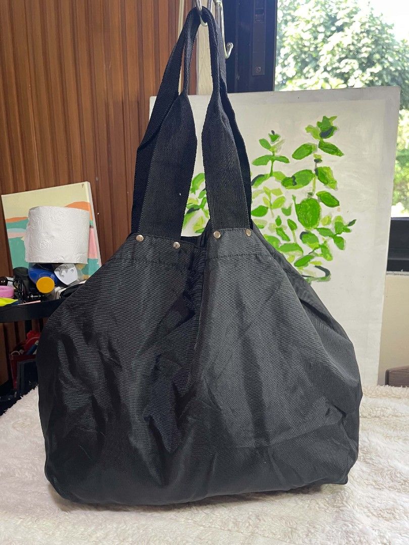 Black Fabric Tote Bag with Sturdy Straps (Category: Tote Bags) located in Naawan. Submitted by twilly.apparel2 (Listing ID 1465819002, Image 3). Description: - Color: Versatile black - Material: Durable textured fabric - Straps: Sturdy dual woven shoulder straps with secure metal rivets - Design: Roomy interior with a deep base - Best for: Daily errands, grocery runs, and casual everyday use - Style: Neutral dark color that matches any outfit.