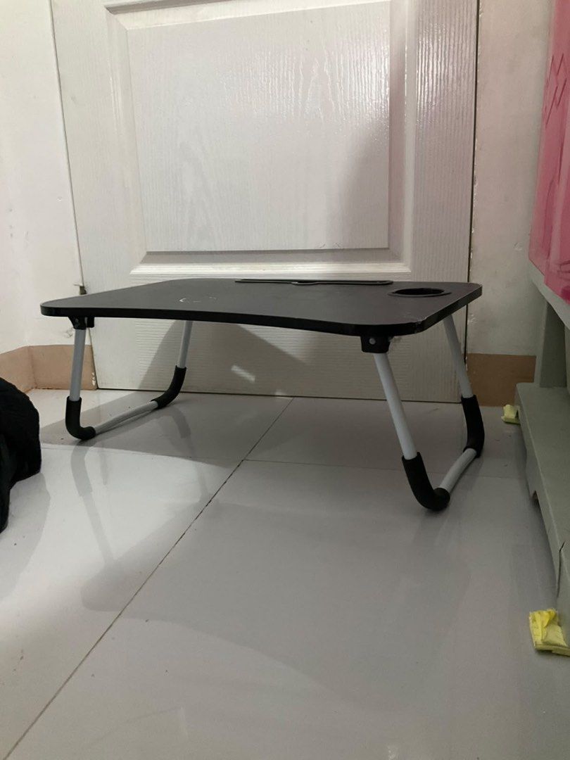 Black Foldable Lazy Bed Desk with Cup Holder (Category: Tables & Sets) located in Jaen. Submitted by blaire.mayoph (Listing ID 1465932669, Image 2). Description: 2ND HAND FOLDABLE LAPTOP TABLE / BED TABLE | ₱180 ONLY Selling this 2nd hand foldable laptop/bed table for only ₱180. Used only a few times and still in good condition. RFS: Mas ginagamit ko na kasi ang PC ko, kaya natatambak lang ito. Sayang naman kung hindi magamit ng iba. 😊 ✨ Feature