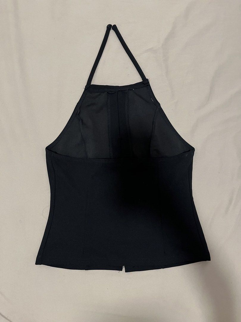 Black halter top ribbon (Category: Sleeveless) located in Marikina City. Submitted by maicsg_ (Listing ID 1465772869, Image 2). Description: - Color: Black - Style: Halter top, backless with thin straps - Details: Three rhinestone bows along the front slit - Fit: Fitted cut - Condition: Excellent (worn once for photos only, clean and ready to wear) - Styling tip: Pairs easily with denim shorts or skirts.