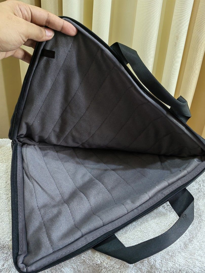 Black Laptop Sleeve Bag with Handles (Category: Laptop Bags & Sleeves) located in Makati City. Submitted by prelovedtreatedwithlove (Listing ID 1465785969, Image 2). Description: - Brand :Targus -Color: Sleek black with a grey quilted interior - Protection: Padded main compartment for extra safety - Storage: Zippered front pocket for accessories - Portability: Sturdy carry handles for easy commuting - Condition : like new - Size: 13x10 inches .