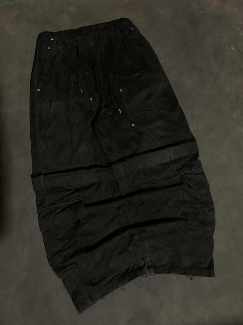 Black Long Cargo Skirt with Drawstring Waist (Category: Jeans) located in Valencia. Submitted by davehandpicked (Listing ID 1465893414, Image 1). Description: - Style: Black utility cargo maxi skirt - Waist: Elastic waistband with adjustable drawstring cords - Pockets: Multiple front patch pockets and side cargo pockets - Details: Heavy distressing at the bottom hem - Wash: Dark washed fabric tone -CARGO DOUBLE KNEE BAGGYPANTS .