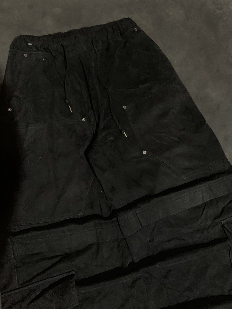 Black Long Cargo Skirt with Drawstring Waist (Category: Jeans) located in Valencia. Submitted by davehandpicked (Listing ID 1465893414, Image 2). Description: - Style: Black utility cargo maxi skirt - Waist: Elastic waistband with adjustable drawstring cords - Pockets: Multiple front patch pockets and side cargo pockets - Details: Heavy distressing at the bottom hem - Wash: Dark washed fabric tone -CARGO DOUBLE KNEE BAGGYPANTS .