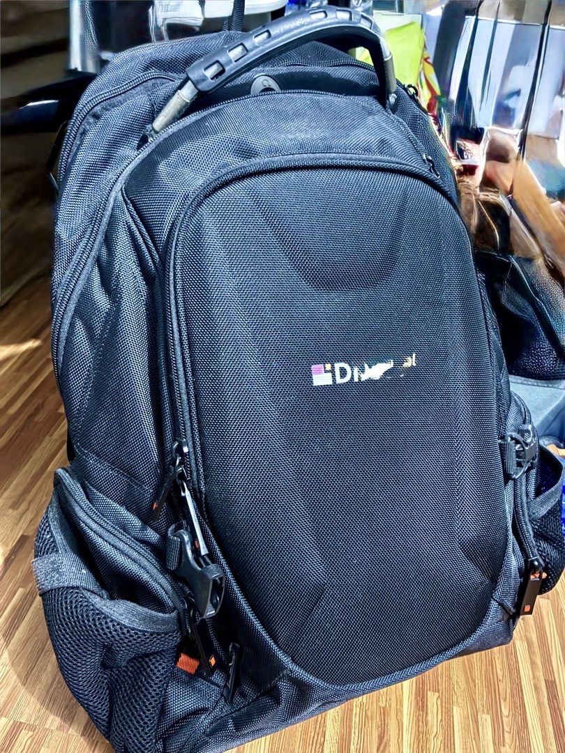 Black Multi-Compartment Tech Backpack (Category: Backpacks) located in Manila. Submitted by jhie24 (Listing ID 1465792092, Image 1). Description: - Color: Sleek black with stylish orange interior accents - Material: Durable textured fabric - Compartments: Multiple zipped compartments inside and out - Laptop Storage: Dedicated padded compartment with a laptop icon tab - Organization: Small internal pocket with icons for phone, media player, and di