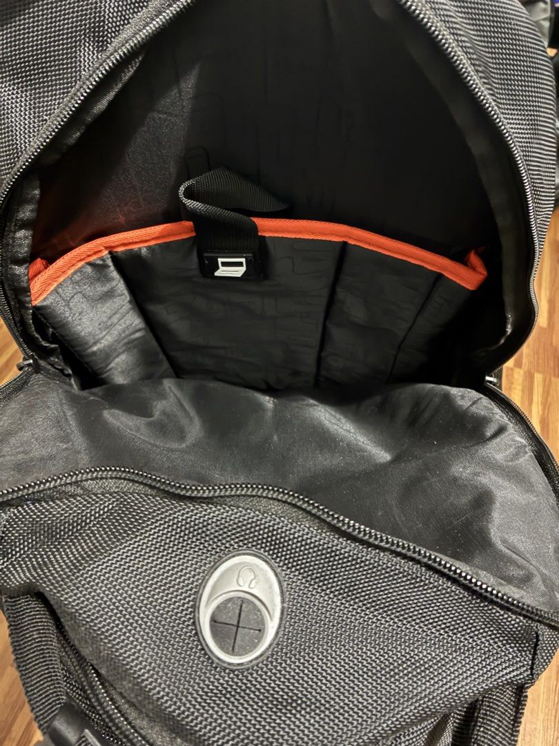Black Multi-Compartment Tech Backpack (Category: Backpacks) located in Manila. Submitted by jhie24 (Listing ID 1465792092, Image 2). Description: - Color: Sleek black with stylish orange interior accents - Material: Durable textured fabric - Compartments: Multiple zipped compartments inside and out - Laptop Storage: Dedicated padded compartment with a laptop icon tab - Organization: Small internal pocket with icons for phone, media player, and di
