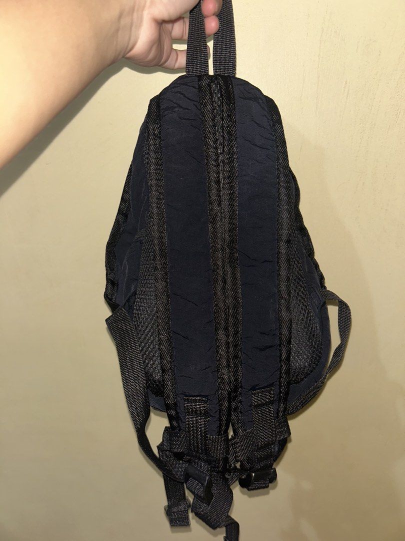 Black Nylon Mini Backpack with Front Pocket (Category: Backpacks) located in Caloocan City. Submitted by karidaaad (Listing ID 1465934195, Image 3). Description: - Color: Solid black - Material: Lightweight crinkled nylon with breathable mesh backing - Compartments: Main zippered compartment + front pocket with bungee cord detail - Comfort: Adjustable padded shoulder straps and top grab handle - Best for: Daily commutes, travel, and quick errands