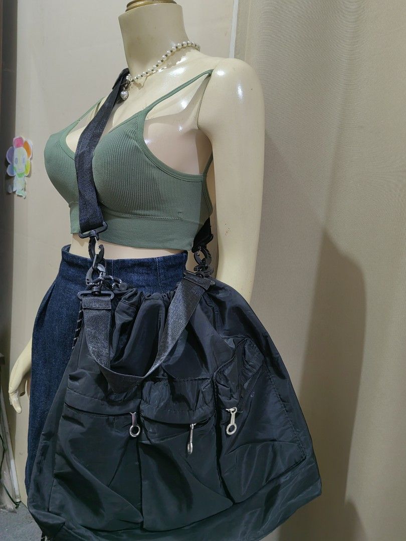 Black Nylon Utility Shoulder Bag with Multiple Pockets (Category: Shoulder Bags) located in Makati City. Submitted by prelovedtreatedwithlove (Listing ID 1465829496, Image 2). Description: Black nylon shoulder bag, roomy interior. Drawstring closure on top. Multiple exterior pockets with ring pull zippers. 2 ways good for daily errands or casual outings. No issue A-240.