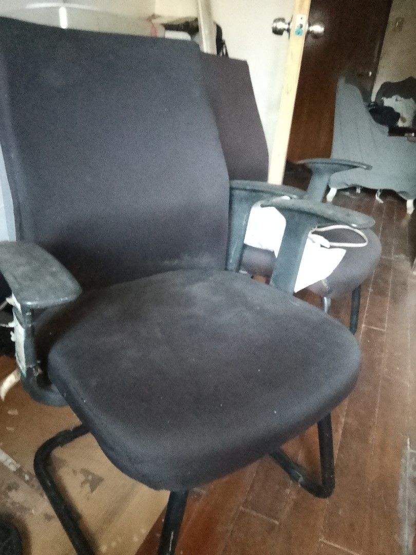 Black Office Chair with Armrests (Category: Office Furniture & Fixtures) located in Manila. Submitted by cleverocean.10acf9 (Listing ID 1465950647, Image 1). Description: - Type: Black office chair with sturdy metal frame - Material: Fabric upholstery on seat/backrest with plastic armrests - Base: Fixed cantilever legs for maximum stability - Size: Standard size, ideal for home offices or meeting rooms - Condition: Dusty from storage, needs a qui