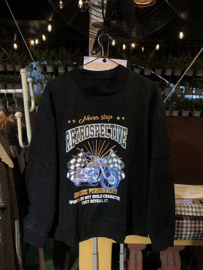 Black Retrospective Motorcycle Graphic Sweatshirt (Category: Coats, Jackets and Outerwear) located in Cauayan City . Submitted by wholly.craaaft (Listing ID 1465875361, Image 1). Description: - Color: Black with solid black back - Design: Blue motorcycle graphic with checkered flags and inspiring typography on the front - Style: Crewneck sweatshirt with long sleeves - Details: Ribbed collar, cuffs, and hem for a snug fit - Perfect for casual stre