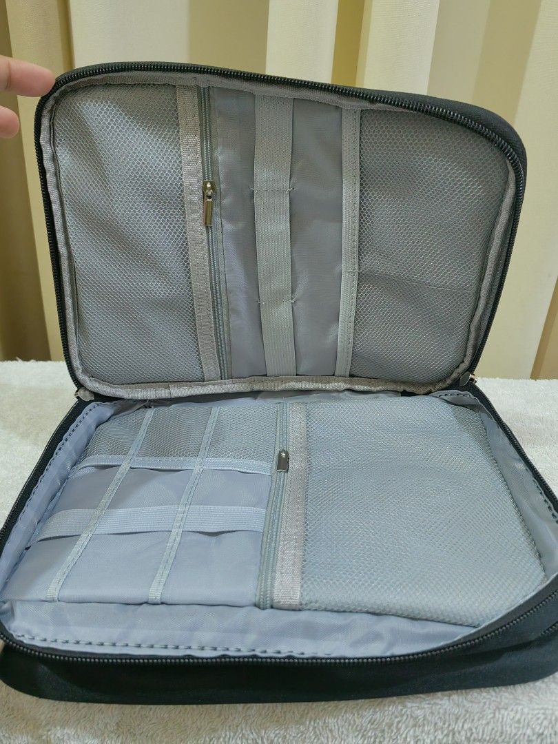 Black Travel Electronics Organizer Bag Cable Storage Case (Category: Accessory Holder, Box & Organizers) located in Makati City. Submitted by prelovedtreatedwithlove (Listing ID 1465820639, Image 3). Description: - Color: Sleek black - Storage: Multiple mesh zipper pockets, elastic loops, and adjustable Velcro dividers - Security: Secure zip-around closure keeps all your gadgets in place during travel - Perfect for: Organizing cables, chargers, p