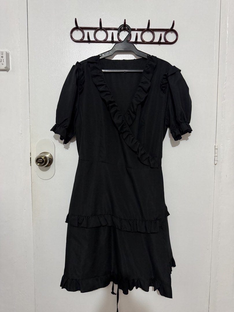 Black V-neck Ruffle Mini Dress with Tie Back (Category: Dresses) located in Las Pinas. Submitted by milkydeclutter (Listing ID 1465937554, Image 1). Description: - Color: Black - Style: Mini dress with short sleeves and flowy shape - Details: Playful ruffles on V-neckline and tiered skirt - Fit: Adjustable tie-back waist for a custom fit - Fabric: Lightweight and comfortable - Occasion: Great for casual outings or dinner dates.
