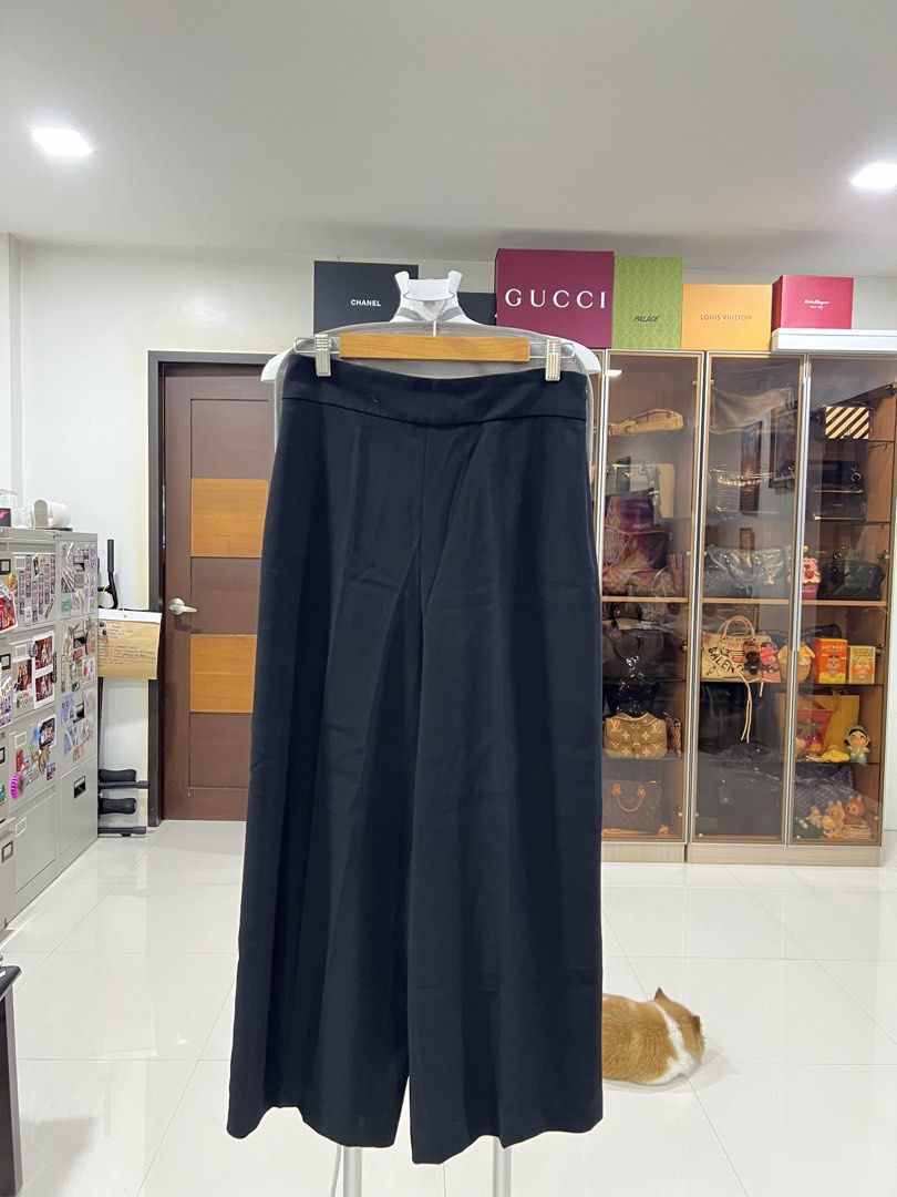 Black wide-leg trousers pants (Category: Jeans) located in Manila. Submitted by imprincessg888 (Listing ID 1465858369, Image 1). Description: - Color: Solid black - Fit: High-waisted with a standard fit through the hips - Style: Clean tailored finish that drapes straight down - Versatility: Easy to dress up for the office or style casually with a basic tee - Pairing: Neutral color that matches everything in your wardrobe.