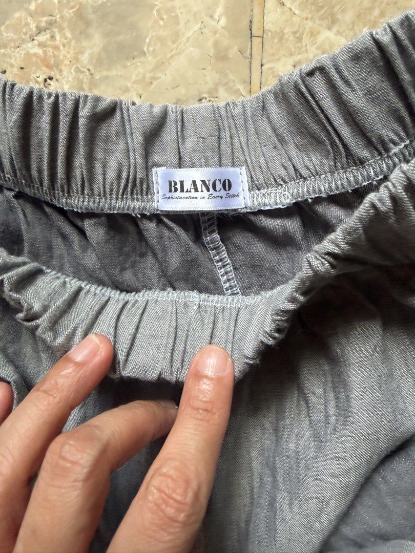 BLANCO Grey Wide Leg Wrap Pants (Category: Jeans) located in Angeles City. Submitted by reginageorge22 (Listing ID 1465803119, Image 2). Description: - Brand: Blanco - Color: Grey - Style: Wide leg pants with front wrap overlay (skirt-like look) - Waistband: Elastic with matching tie belt - Fabric: Lightweight and breathable, ideal for warm weather. Linen blend - Fit: Easy slip-on design for ultimate comfort Never used- not really my personality.