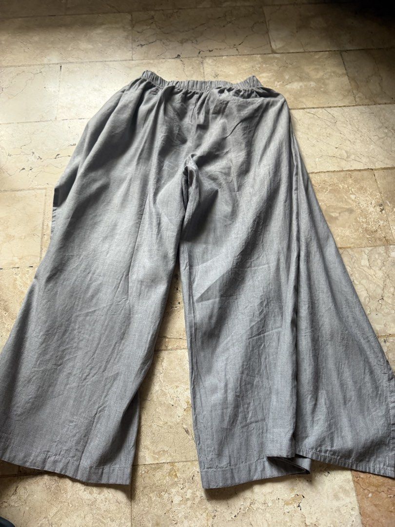 BLANCO Grey Wide Leg Wrap Pants (Category: Jeans) located in Angeles City. Submitted by reginageorge22 (Listing ID 1465803119, Image 3). Description: - Brand: Blanco - Color: Grey - Style: Wide leg pants with front wrap overlay (skirt-like look) - Waistband: Elastic with matching tie belt - Fabric: Lightweight and breathable, ideal for warm weather. Linen blend - Fit: Easy slip-on design for ultimate comfort Never used- not really my personality.