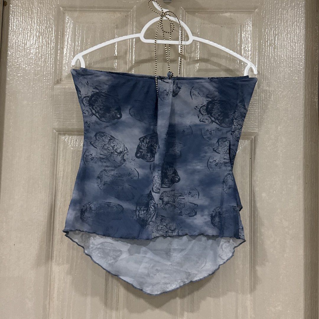 Blue abstract print halter tube top (Category: Sleeveless) located in Makati City. Submitted by julyco. (Listing ID 1465809167, Image 2). Description: - Style: Halter tube top with blue and grey abstract print - Details: Ruched front neckline with thin beaded center strap - Hem: Asymmetrical curved hem with lettuce-edge finish - Fabric: Sheer, lightweight, and breathable - Versatility: Perfect for summer nights or easy layering.