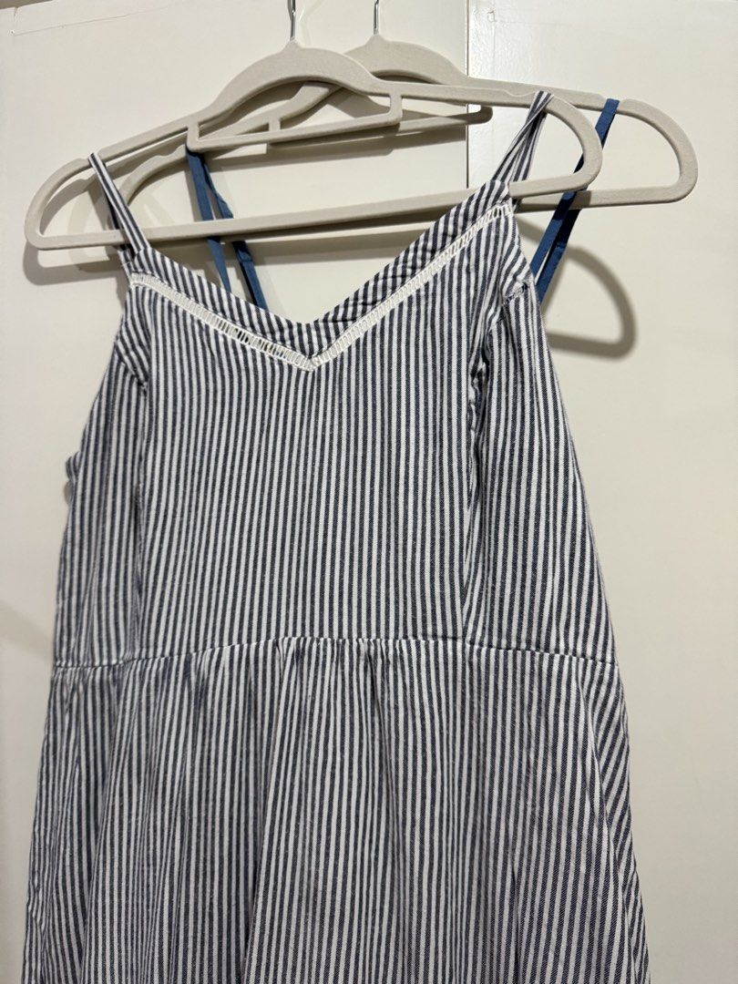 Blue and White Striped Sleeveless Dress (Category: Dresses) located in Manila. Submitted by carmela_andd (Listing ID 1465904921, Image 1). Description: - Style: Blue and white vertical striped cami dress with a knee-length flared skirt - Design: V-neckline with delicate white lace trim and adjustable criss-cross spaghetti straps - Fit: Gathered waistline for a flattering and comfortable fit - Fabric: Lightweight and breezy, perfect for warm weath