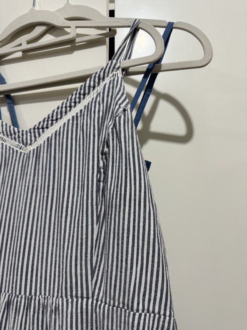 Blue and White Striped Sleeveless Dress (Category: Dresses) located in Manila. Submitted by carmela_andd (Listing ID 1465904921, Image 2). Description: - Style: Blue and white vertical striped cami dress with a knee-length flared skirt - Design: V-neckline with delicate white lace trim and adjustable criss-cross spaghetti straps - Fit: Gathered waistline for a flattering and comfortable fit - Fabric: Lightweight and breezy, perfect for warm weath
