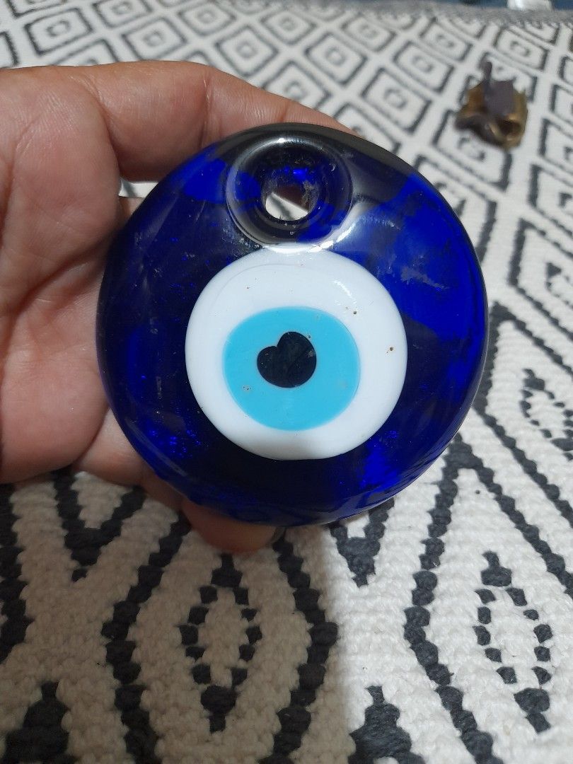 Blue Evil Eye Glass Wall Hanging Talisman (Category: Wall Decor) located in Bocaue. Submitted by marajapansurplus (Listing ID 1465865825, Image 1). Description: - Traditional blue glass evil eye amulet - Features a striking central white, light blue, and black design - Vibrant cobalt blue circular glass piece - Built-in hole near the edge for easy hanging on walls, doors, or windows - Ideal for home protection and good vibes.