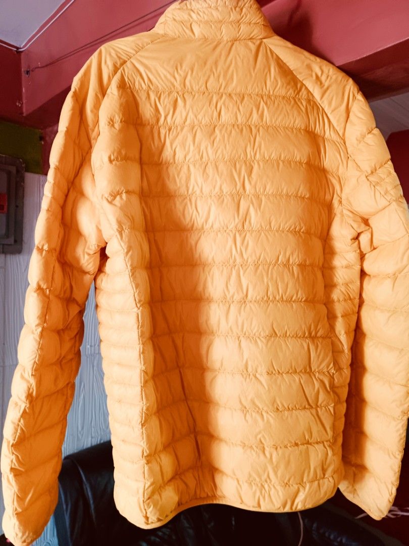 Bossini Yellow Puffer Jacket XL (Category: Coats, Jackets and Outerwear) located in Imus. Submitted by melgibsong24 (Listing ID 1465763996, Image 2). Description: - Brand: Bossini - Color: Bright yellow - Size: XL (22 inches across the chest) - Design: Quilted puffer jacket with zip-up front and high collar - Pockets: Convenient zippered pockets on both sides - Condition/Features: Great warmth without feeling too heavy - Note: Grab it before some
