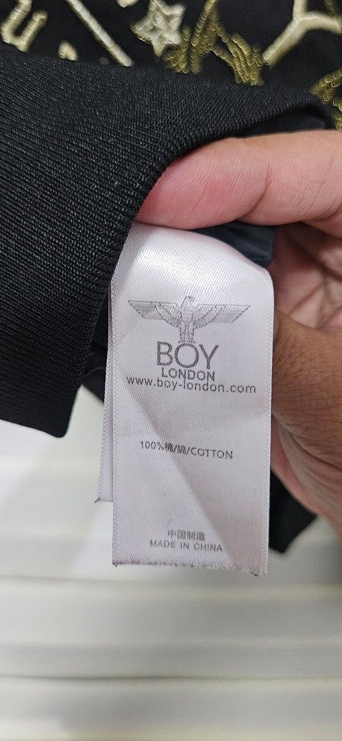 Boy London Bomber Jacket Black Gold (Category: Coats, Jackets and Outerwear) located in Santa Maria. Submitted by rommelmateo (Listing ID 1465922430, Image 3). Description: - Brand: Boy London - Color: Black with gold embroidery - Material: 100% cotton - Features: Zip-up front, ribbed cuffs and hem - Design: Graphic eagle logo on the back and skull details on the sleeves - Origin: Made in China - Condition: Excellent pre-loved condition (ready to