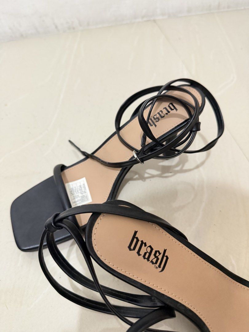 Brash Black Strappy Heels Size 6.5 (Category: Heels) located in Taguig. Submitted by paucsn (Listing ID 1465945050, Image 3). Description: - Brand: Brash - Size: 6.5 - Color: Black with tan inner sole - Style: Strappy heels with square toe and stiletto heel - Details: Thin wrap-around ankle straps - Condition: Minor scuffs on the sole from storage/handling RFS: Di na nagagamit Can do meet up within Market Market Bgc Ship via lalamove/lbc.