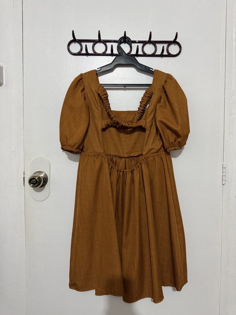 Brown / Rust Orange Square Neck Puff Sleeve Dress Open Back (Category: Dresses) located in Las Pinas. Submitted by milkydeclutter (Listing ID 1465937632, Image 2). Description: - Color: Earthy caramel brown - Neckline: Square neck with short puff sleeves - Waist: High waistline with gathered skirt detailing - Back Design: Statement cutout back with ruffled elastic trim - Material: Textured fabric, easy slip-on fit - Occasion: Perfect for casual e