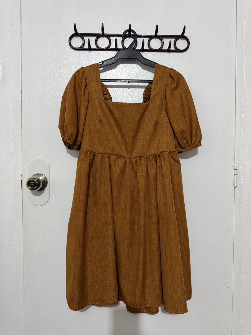 Brown / Rust Orange Square Neck Puff Sleeve Dress Open Back (Category: Dresses) located in Las Pinas. Submitted by milkydeclutter (Listing ID 1465937632, Image 1). Description: - Color: Earthy caramel brown - Neckline: Square neck with short puff sleeves - Waist: High waistline with gathered skirt detailing - Back Design: Statement cutout back with ruffled elastic trim - Material: Textured fabric, easy slip-on fit - Occasion: Perfect for casual e