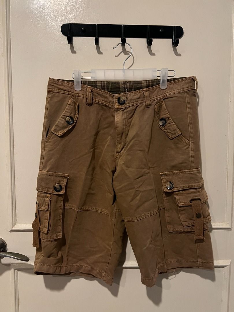 Brown Cargo Shorts with Multiple Pockets [s3] (Category: Shorts) located in Pasig City. Submitted by awesamfinds (Listing ID 1465840600, Image 1). Description: - Color: Brown - Length: Knee-length fit - Pockets: Multiple utility pockets with button flaps on sides and back - Durability: Reinforced seat panel for extra strength - Closure: Button fly - Extra: Stylish plaid waistband lining inside - Style: Rugged streetwear, ideal for outdoor activit