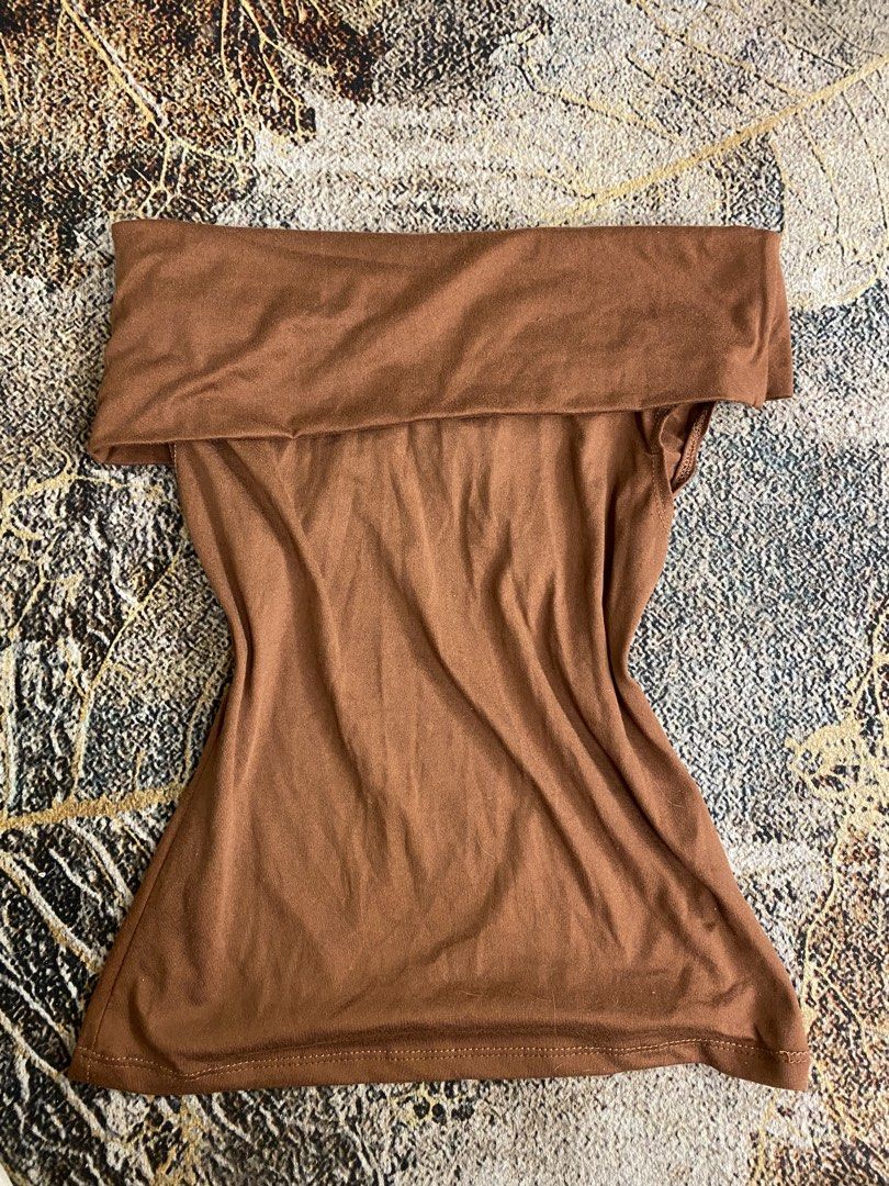 Brown Off-Shoulder Foldover Top (Category: Blouses) located in Manila. Submitted by ariane0422 (Listing ID 1465867428, Image 1). Description: - Color: Brown - Style: Off-shoulder with a wide foldover collar - Fit: Fitted through the waist with a subtle flare at the hem - Material: Super soft and stretchy knit fabric - Versatility: Perfect everyday basic, easy to dress up or down with jeans or a skirt.