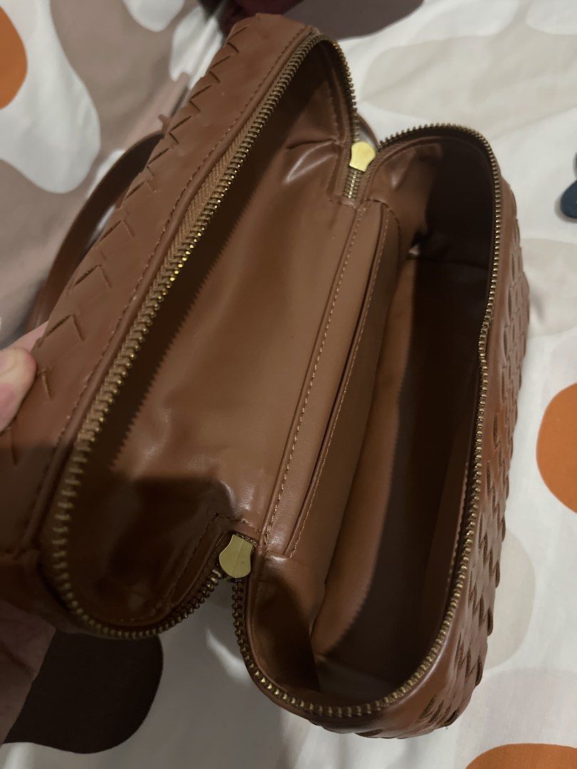 Brown Woven Leather Vanity Bag Crossbody (Category: Cross-body Bags) located in Las Pinas. Submitted by erenrosc (Listing ID 1465893604, Image 3). Description: - Brown faux leather with an all-over woven pattern - Structured boxy shape with gold-toned hardware - Double zipper closure and top handle - Includes an adjustable and detachable crossbody strap - Smooth interior lining with a handy slip pocket - Compact size, perfect for daily essentials