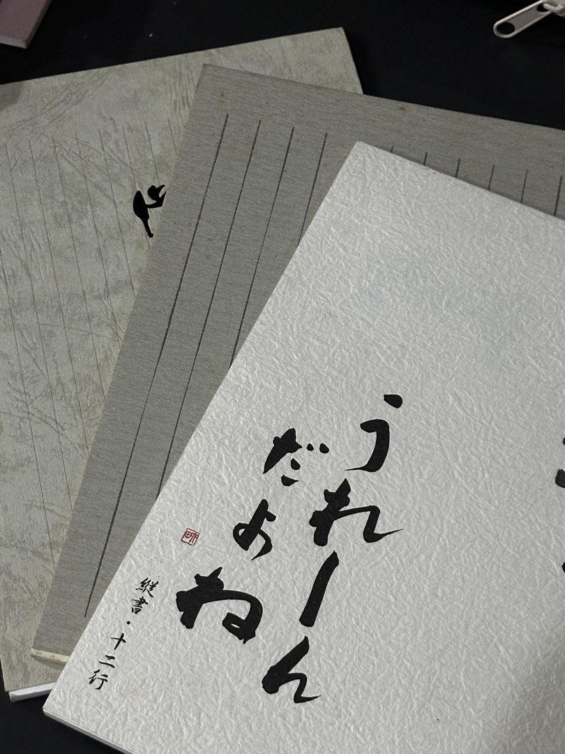 [BUNDLE] Japanese Calligraphy Pads (Category: Stationery & School Supplies) located in Manila. Submitted by sharksfin06 (Listing ID 1465893962, Image 1). Description: - Type: Traditional Japanese vertical writing notebooks - Quantity: Set of 3 with different textured white and grey covers - Layout: 12 lines per page, clean and unused - Paper Quality: High-grade paper, perfect for brush pen practice or letter writing - Condition: Brand new, pristi
