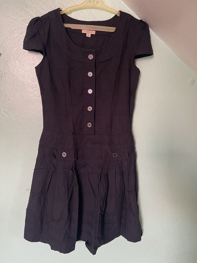 Burberry Brit Black Dress Size M (Category: Dresses) located in Baybay. Submitted by shikita27906 (Listing ID 1465845952, Image 1). Description: - Brand: Burberry Brit - Size: Medium - Color: Black with subtle tonal check pattern - Style: Classic fit and flare silhouette - Details: Short cap sleeves, round neckline, engraved button-down front, and two pleated waist pockets with button flaps.