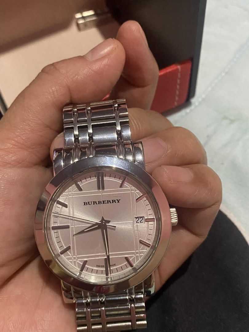 Burberry silver analog watch with date display (Category: Women's Watches) located in Manila. Submitted by goodbuying_items0211 (Listing ID 1465776109, Image 3). Description: - Authentic Burberry silver-tone analog watch - Iconic textured check pattern dial with a 3 o'clock date window - Durable stainless steel linked bracelet with a secure deployment clasp - Swiss made movement for reliable timekeeping - Fully functional and well-kept condition 