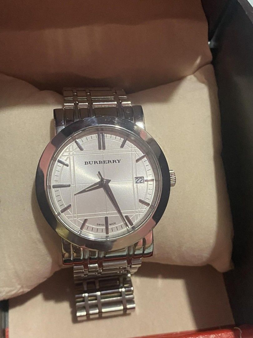 Burberry silver analog watch with date display (Category: Women's Watches) located in Manila. Submitted by goodbuying_items0211 (Listing ID 1465776109, Image 1). Description: - Authentic Burberry silver-tone analog watch - Iconic textured check pattern dial with a 3 o'clock date window - Durable stainless steel linked bracelet with a secure deployment clasp - Swiss made movement for reliable timekeeping - Fully functional and well-kept condition 