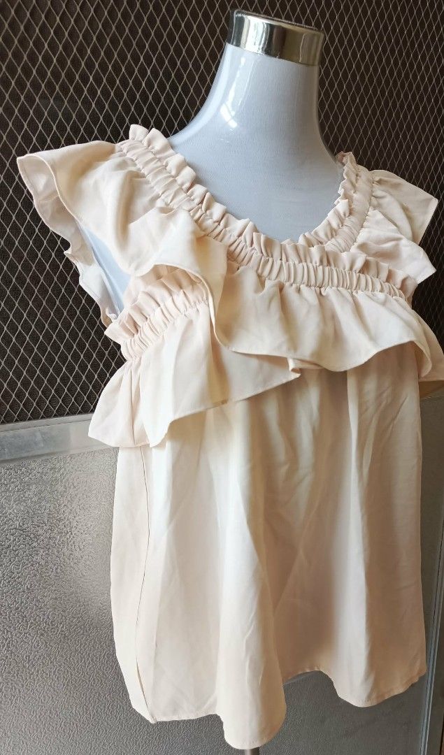BZD Studio Ruffled Beige Top (Category: Blouses) located in Cebu City. Submitted by violacloset (Listing ID 1465891280, Image 2). Description: - Color: Soft beige - Style: Sleeveless with ruffled layered collar and elastic neckline - Details: gartered shoulders and relaxed fit - Measurements: length: 24 width: 18 shoulder length: 17.