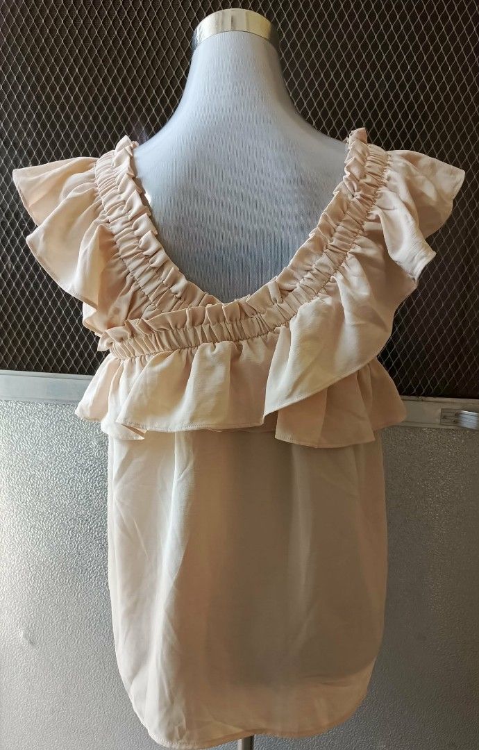 BZD Studio Ruffled Beige Top (Category: Blouses) located in Cebu City. Submitted by violacloset (Listing ID 1465891280, Image 3). Description: - Color: Soft beige - Style: Sleeveless with ruffled layered collar and elastic neckline - Details: gartered shoulders and relaxed fit - Measurements: length: 24 width: 18 shoulder length: 17.